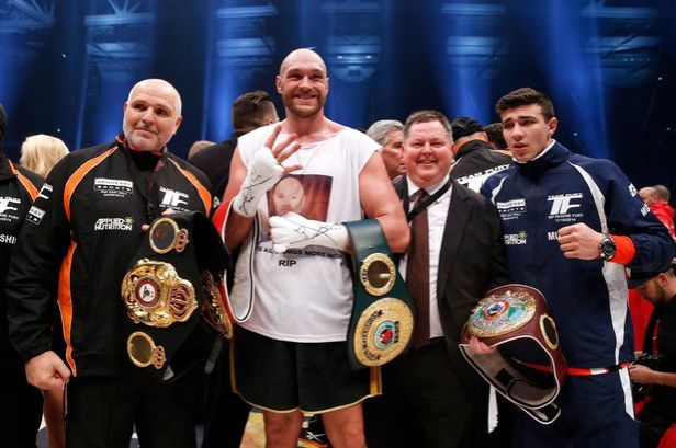 Peter Fury (left) standing next to his nephew Tyson Fury (centre) on 28 Nov 2015 after beating Wladimir Klitschko to win the world heavyweight title
